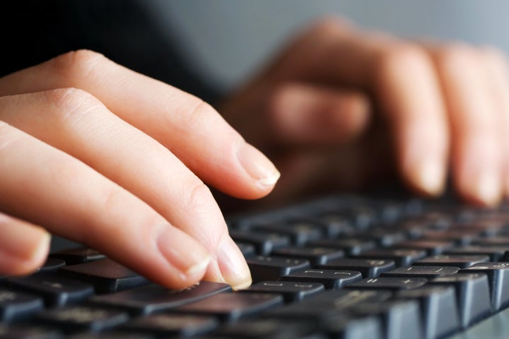 Female hands typing on computer keyboard