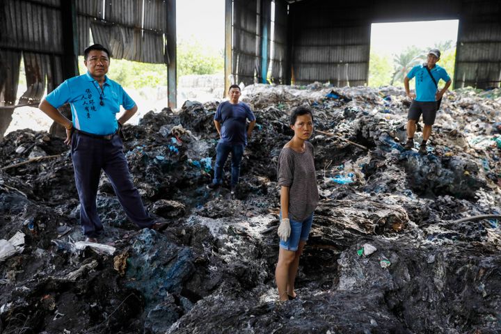 Pua poses with volunteers at an illegal plastic recycling factory in Kuala Langat on Feb. 2, 2019.