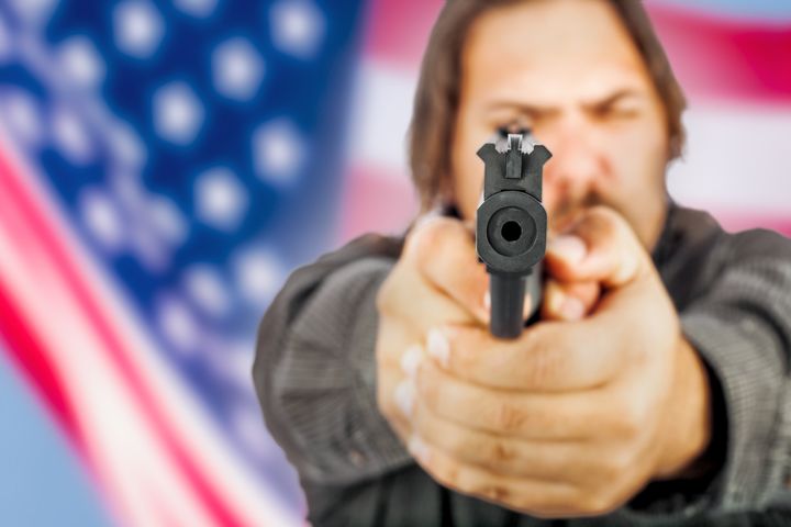white male holding a handgun...