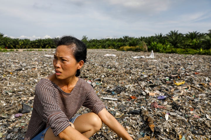 A local activist shows HuffPost an illegal plastic dumpsite hidden inside a palm oil plantation in Kuala Langat, Malaysia, in early 2019. 