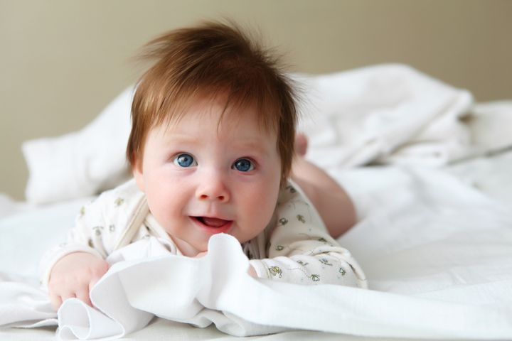 portrait of beautiful redhead infant with blue eyes