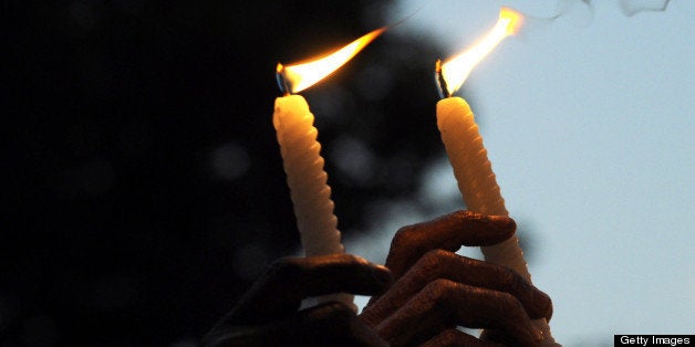 Indian activists take part in a candlelight vigil in Kolkata on December 30, 2012, after the cremation ceremony for a gangrape victim. The victim of a gang-rape and murder which triggered an outpouring of grief and anger across India was cremated at a private ceremony, hours after her body was flown home from Singapore. A student of 23-year-old, the focus of nationwide protests since she was brutally attacked on a bus in New Delhi two weeks ago, was cremated away from the public glare at the request of her traumatised parents.AFP PHOTO/Dibyangshu SARKAR (Photo credit should read DIBYANGSHU SARKAR/AFP/Getty Images)