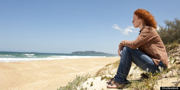 pensive woman sitting on the...