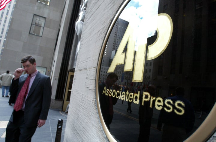 NEW YORK - JANUARY 9: A man walks out of Associated Press (AP) headquarters January 9, 2003 in New York City. Because of a contract dispute about 1,700 reporters, photographers and other editorial workers at the Associated Press will withhold their bylines today. (Photo by Mario Tama/Getty Images) 