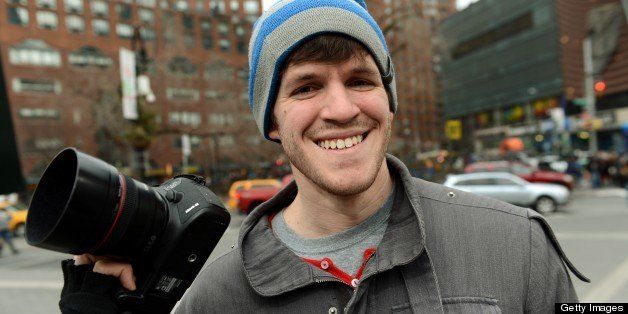 Brandon Stanton, creator of the Humans of New York blog, with his camera February 22, 2013 across the street from Union Square in New York. Some like New York's skyscrapers, bridges, his energy, taxis or lights. But Brandon Stanton has set himself another challenge: photograph of 10,000 inhabitants for a blog now famous 'Humans of New York.' In two years, he has photographed 5,000 New Yorkers, children leaving school, tramps, fashionistas, New York with a bouquet of tulips, old lady with a cane, municipal employees, etc. And nearly 560,000 fans now follow his Facebook page.AFP PHOTO/Stan HONDA (Photo credit should read STAN HONDA/AFP/Getty Images)