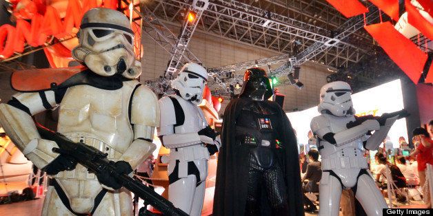Darth Vader and Storm Troopers pose for visitors for the demonstration of the Star Wars videogame software at the software developer Konami's booth during the annual Tokyo Game Show in Chiba, suburban Tokyo, on September 20, 2012. Some 200 companies exhibited their latest video game hardware and software with some 200,000 people expected to visit the four-day vent. AFP PHOTO / Yoshikazu TSUNO (Photo credit should read YOSHIKAZU TSUNO/AFP/GettyImages)