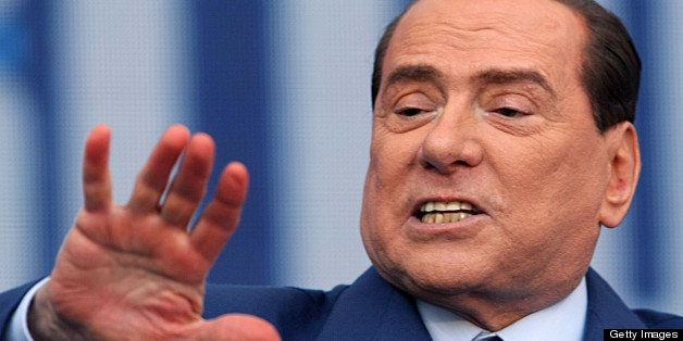 Italia's former Prime minister and leader of centre-right coalition People of Freedom party (PDL) Silvio Berlusconi gives a speech as part of a meeting, on April, 13, 2013 in Bari. AFP PHOTO (Photo credit should read -/AFP/Getty Images)
