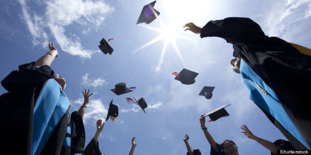 Students throwing graduation hats in the air celebrating