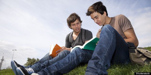 two young student reading books ...