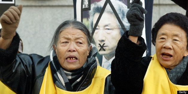 SEOUL, SOUTH KOREA - JANUARY 14: Former 'comfort women' who served as sex slave for Japanese troops during World War II, shout anti Japan slogans during a rally in front of the Japanese embassy on January 14, 2004 in Seoul, South Korea. Activists have angrily protested when Japan urged South Korea to reverse its decision to isssue stamps soon to be released on January 16, 2004 featuring the cluster of islets, known as Dokdo. The Islets lie halfway between South Korea and Japan, and is the center of a territorial dispute. Dokdo has been occupied by South Korean coast guards and patrolled by the South Korean navy for decades, but Tokyo has also claimed the islets. (Photo by Chung Sung-Jun/Getty Images)
