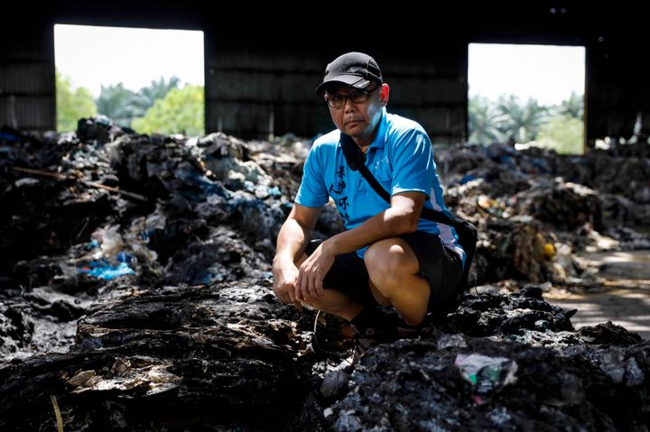 C.K., a volunteer, poses for a portrait at an illegal plastic recycling factory in Kuala Langat.