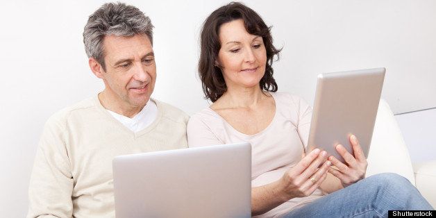 mature couple using laptop and...