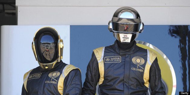 French Daft Punk band members pose in the pits at the Monaco Formula One Grand Prix at the Circuit de Monaco in Monte Carlo on May 26, 2013. AFP PHOTO / BORIS HORVAT (Photo credit should read BORIS HORVAT/AFP/Getty Images)