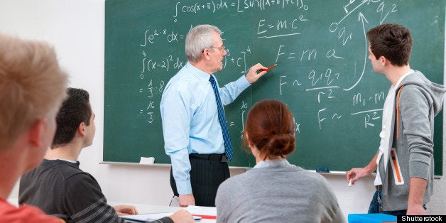 Teacher with a group of high school students in classroom