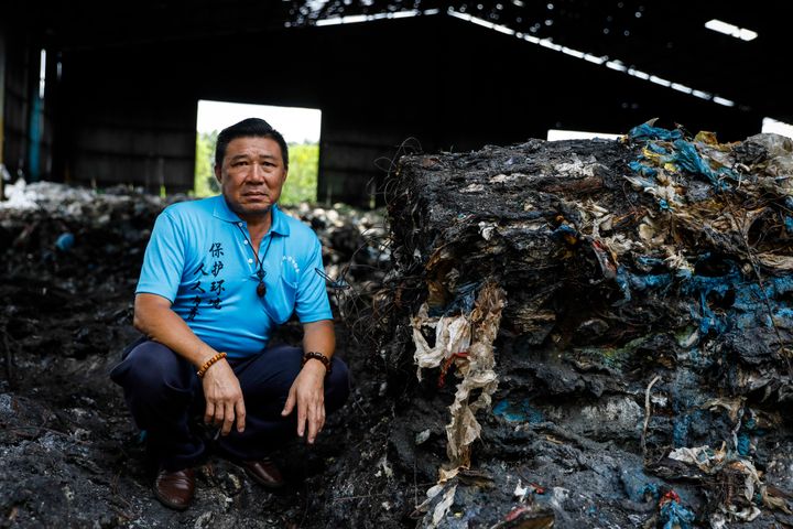 Tan, a volunteer, poses for a portrait at an illegal plastic recycling factory in Kuala Langat.