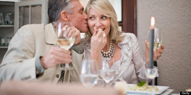 Couple kissing at table in restaurant