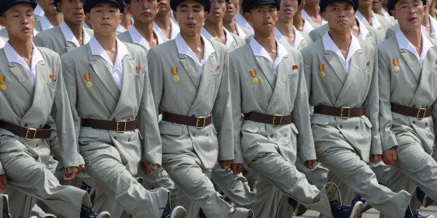 In a photo taken on July 27, 2013 North Korean soldiers march through Kim Il-Sung square during a military parade marking the 60th anniversary of the Korean war armistice in Pyongyang. North Korea mounted its largest ever military parade on July 27 to mark the 60th anniversary of the armistice that ended fighting in the Korean War, displaying its long-range missiles at a ceremony presided over by leader Kim Jong-Un. AFP PHOTO / Ed Jones (Photo credit should read Ed Jones/AFP/Getty Images)