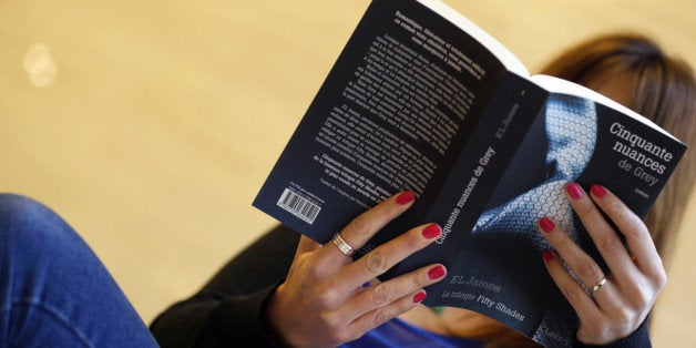 A picture taken on October 16, 2012 shows a woman reading a copy of 'Fifty Shades of Grey' ('Cinquante nuances de Grey' in French) by British author E.L. James in Paris. This novel will be on sale in France on October 17 and published by JC Lattes house. AFP PHOTO KENZO TRIBOUILLARD (Photo credit should read KENZO TRIBOUILLARD/AFP/Getty Images)