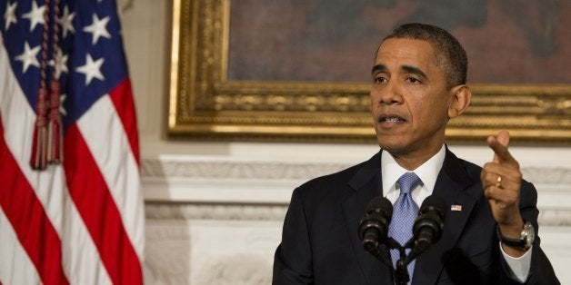 US President Barack Obama speaks about the reopening of the US government following a shutdown, in the State Dining Room of t