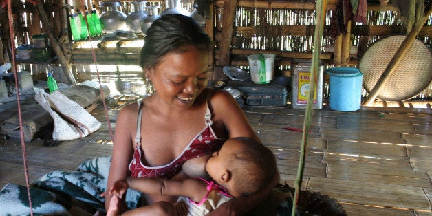 An Indian tribal woman breastfeeds her baby in Hadraibari, some 45 km east of Agartala, on July 31, 2009, on the eve of Breas
