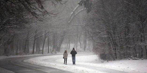 NEW YORK, NY - MARCH 08: People walk through a snow-shrouded park on March 8, 2013 in the Brooklyn borough of New York City. As a week-old storm slowly moves out to sea, the New York City area is expecting 1 to 3 inches of snow with more in areas north and west of the city. The storm has caused flight delays at area airports and numerous schools have delayed start times. (Photo by Spencer Platt/Getty Images)