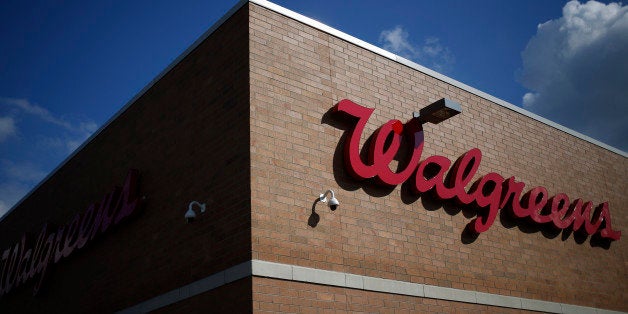 Walgreen Co. signage is displayed outside one of the company's stores in Louisville, Kentucky, U.S., on Monday, Sept. 30, 2013. Walgreen Co., the biggest U.S. drugstore chain, is expected to report fourth-quarter earnings before the opening of U.S financial markets on Oct. 1. Photographer: Luke Sharrett/Bloomberg via Getty Images