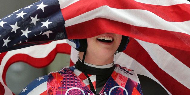 Sochi, Russia - February 11 - SSOLY- American bronze medallist can't quite figure out the right end of the flag to hold up.At the Winter Olympics in Sochi, the finals of women's luge was held at the Sanki sliding centre.February 11, 2014 (Richard Lautens/Toronto Star via Getty Images)
