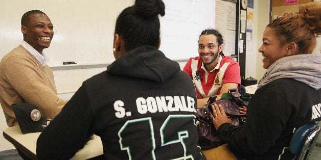 WEST ROXBURY, MA - MAY 15: Adrian Martin of PricewaterhouseCoopers, far left, seniors Selena Gonzales, back, Luis Capriles, middle, and Katherine Chavez, right, worked on an effective elevator pitch during a networking class at West Roxbury Academy, Wednesday, May 15, 2013. (Photo by Wendy Maeda/The Boston Globe via Getty Images)