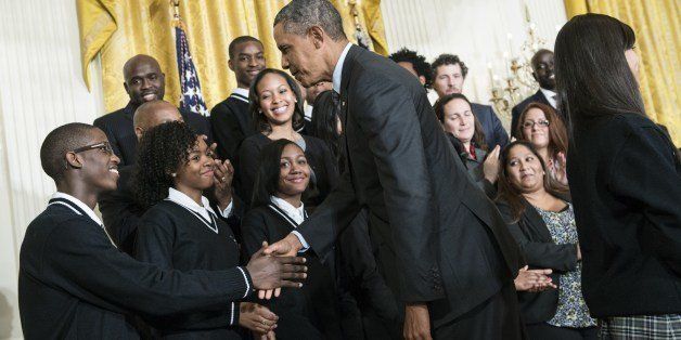 US President Barack Obama greets members of the Harlem Children's Zone Promise Academy after speaking about poverty during an event in the East Room of the White House's private dining room January 9, 2014 in Washington, DC. Obama announced five locations where his administration hopes to combat poverty including San Antonio, Philadelphia, Los Angeles, southeastern Kentucky and the Choctaw Nation of Oklahoma. AFP PHOTO/Brendan SMIALOWSKI (Photo credit should read BRENDAN SMIALOWSKI/AFP/Getty Images)