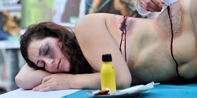 Activists of the animal-rights group 'AnimaNaturalis' stage a protest against the vivisection and experiments on animals at Sant Jaume square, in the centre of Barcelona on October 20, 2013. AFP PHOTO/ JOSEP LAGO (Photo credit should read JOSEP LAGO/AFP/Getty Images)