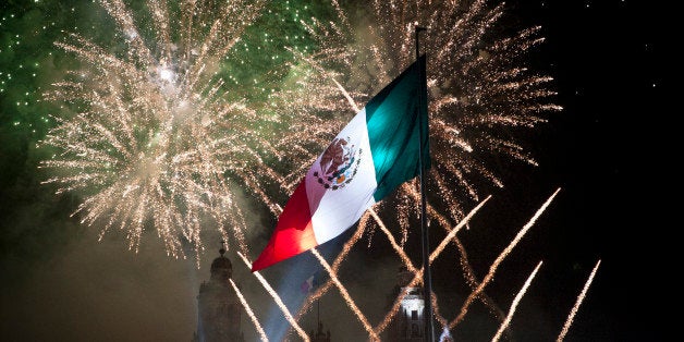 MEXICO CITY, MEXICO SEPTEMBER 16: Fireworks explode at the Mexico City Zocalo during the anniversary of the 'Grito de Dolores' made by the priest Miguel Hidalgo in 1810 to begin the struggle for independence against Spain on September 07, 2013 in Mexico City, Mexico. (Photo by Annick Donkers/LatinContent/Getty Images)