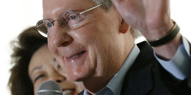 LOUISVILLE, KY - MAY 19: U.S. Senate Republican Leader Sen. Mitch McConnell (R-KY) speaks to supporters while campaigning at an early morning rally with his wife Elaine Chao May 19, 2014 in Louisville, Kentucky. McConnell has a full day of campaigning scheduled in advance of tomorrow's Republican primary against challenger Matt Bevin. (Photo by Win McNamee/Getty Images)