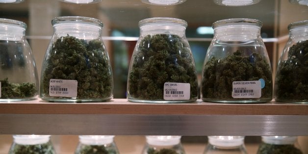 Jars containing various strands of medical marijuana sit behind a display case at the River Rock Medical Marijuana Center in
