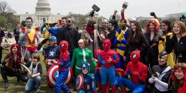 People dressed in superhero-style costumes line up for a photo near the US Capitol in Washington, DC on April 18, 2014, in a