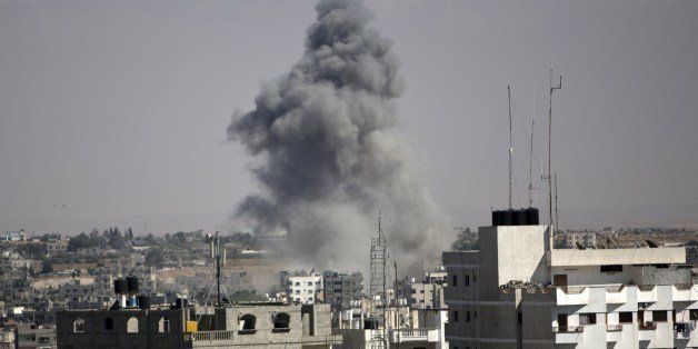 Smoke rises following an Israeli strike in Rafah, in the southern Gaza Strip on August 3, 2014. At least 10 people were killed in a fresh strike on a UN school in southern Gaza which was sheltering Palestinians displaced by an Israeli military offensive, medics said. AFP PHOTO / MAHMUD HAMS (Photo credit should read MAHMUD HAMS/AFP/Getty Images)
