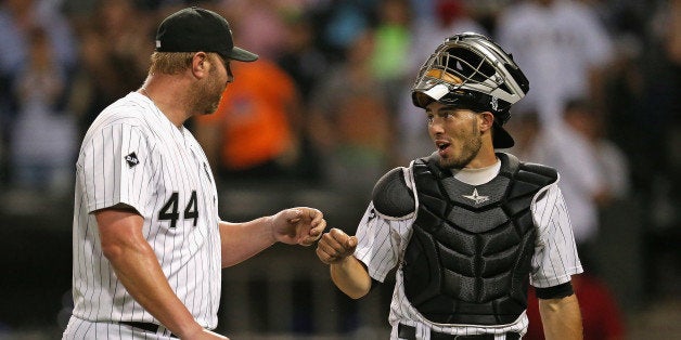 CHICAGO, IL - AUGUST 05: Adam Dunn #44 of the Chicago White Sox is congratulated by Adrian Nieto #17 after pitching in the 9th inning against the Texas Rangers at U.S. Cellular Field on August 5, 2014 in Chicago, Illinois. The Rangers defeated the White Sox 16-0. (Photo by Jonathan Daniel/Getty Images)