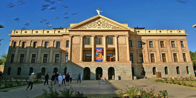 ** ADVANCE FOR SUNDAY DEC. 2 AND THEREAFTER ** Citizens tour the Arizona Capitol grounds in Phoenix in this Dec. 14, 2004 file photo. For decades, the century-old Arizona Capitol has served as the home of a state museum that attracts mostly school classes and tour groups. But now there's renewed talk of putting the copper-domed building back in the business of hosting at least part of working state government. The possibility of using the Capitol once again for legislative offices, hearing rooms or even floor sessions is being considered by a task force appointed by legislative leaders and consisting of lawmakers and others. (AP Photo/Matt York)