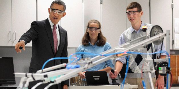 ALEXANDRIA, VA - SEPTEMBER 16: U.S. President Barack Obama visits a classroom and watches students Meghan Clark and Nathan Hughes (R) demonstrate the FIRST Robot, a robot created in the schoolâs prototyping and robotics senior research labs for last yearâs FIRST Robotics Competition, at Thomas Jefferson High School for Science and Technology September 16, 2011 in Alexandria, Virginia. Later in the morning Obama signed the America Invents Act, which reforms patent law so to give a patent to the first applicant rather than the first inventor and allows the woefully underfunded U.S. Patent and Trade Office to set and potentially keep its own fees. (Photo by Chip Somodevilla/Getty Images)