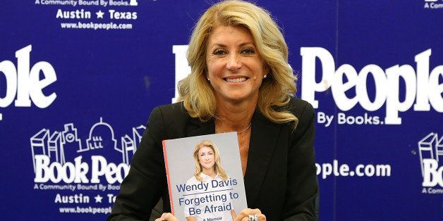 AUSTIN, TX - SEPTEMBER 11: Wendy Davis poses with a copy of her new book 'Forgetting To Be Afraid' at Book People on September 11, 2014 in Austin, Texas. (Photo by Gary Miller/Getty Images)
