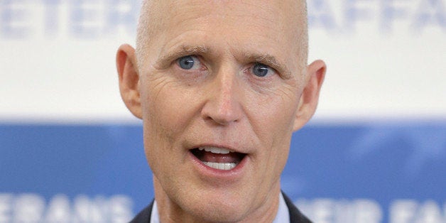 FILE- In this April 29, 2014 file photo, Florida Gov. Rick Scott speaks to members of the media after a ceremony during which