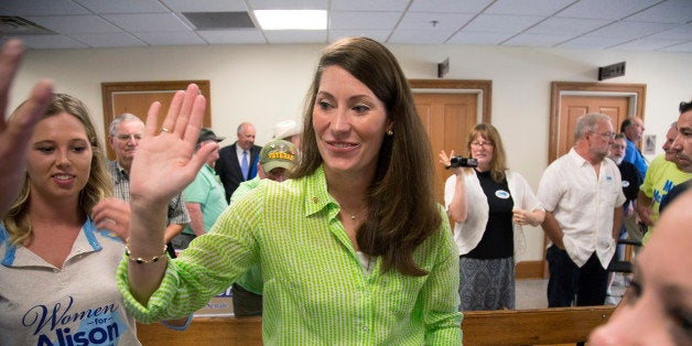 FILE - This July 30, 2014, file photo shows U.S. Senate candidate and Kentucky Secretary of State Alison Lundergan Grimes, as she greets a group of supporters during a campaign stop at the Bullitt County Courthouse in Shepherdsville, Ky. After 30 years in the Senate, now seeking six more, Minority Leader Mitch McConnell of Ky., isn't terribly popular at home. Fortunately for him, President Barack Obama is politically toxic, a fact the Republican leader is banking on to help him to victory in the fall against Democratic challenger Alison Lundergan Grimes. (AP Photo/David Stephenson, File)