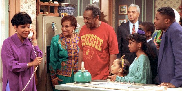 Phylicia Rashad, as Clair Huxtable, talks on the telephone while Bill Cosby, as Dr. Cliff Huxtable and other cast members of the family sitcom "The Cosby Show" gather around during taping of the final episode in New York City, Friday, March 6, 1992. From left clockwise are, Rashad; Clarice Taylor as Anna Huxtable; Cosby; Earl Hyman as Russel Huxtable; unidentified actor, partially hidden; Malcolm Jamal Warner as Theo; Keshia Knight Pulliam as Rudy; and Raven Symone as Olivia. (AP Photo)