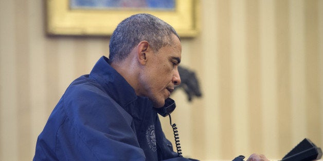 WASHINGTON, DC - OCTOBER 12: U.S. President Barack Obama speaks on the phone with Health and Human Services Secretary Sylvia Burwell for an update on the response to the Ebola diagnosis in Dallas, in the Oval Office of the White House October 12 =, 2014 in Washington DC. A nurse who cared for an Ebola patient was confirmed with the virus. (Photo by Michael Reynolds-Pool/Getty Images)