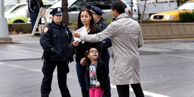 New York City Council District 7 Community Liason Fidel Malena hands out flyers about Ebola risk near the apartment building of Ebola patient Dr. Craig Spencer, in New York, Friday, Oct. 24, 2014. Spencer remained in stable condition while isolated in a hospital, talking by cellphone to his family and assisting disease detectives who are accounting for his every movement since arriving in New York from Guinea via Europe on Oct. 17. (AP Photo/Richard Drew)