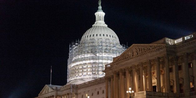 Scaffolding continues to rise around the Capitol Dome for a long-term repair project to fix cracks, leaks and corrosion in the cast-iron structure, Saturday night, Oct. 4, 2014. (AP Photo/J. Scott Applewhite)
