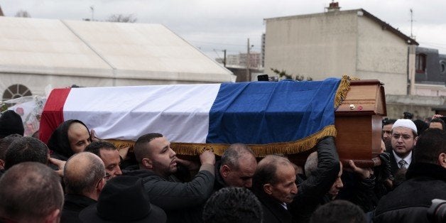 People carry the coffin of French police officer Ahmed Merabet who was killed on January 7 by Islamist gunmen during the attack of French satirical newspaper Charlie Hebdo, during a funeral ceremony on January 13, 2015 in Bobigny, near Paris. Seventeen people, including journalists, policemen, a police woman, Muslims and Jews lost their lives in the attacks in Paris. France has Europe's largest Muslim and Jewish populations and the attacks prompted a historic outpouring of unity and saw nearly four million people rally across the country on January 11. AFP PHOTO / JOEL SAGET (Photo credit should read JOEL SAGET/AFP/Getty Images)