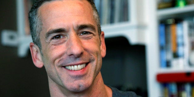 In this photo taken on May 22, 2013, author Dan Savage is in his home in Seattle. Savage's latest book, "American Savage," was released on Tuesday, May 28. (AP Photo/Elaine Thompson)