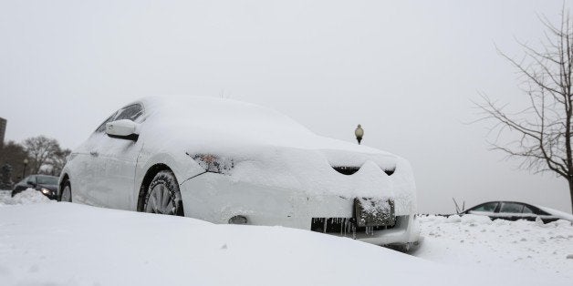 NEW YORK, NY - JANUARY 27: A car is covered with the snow after a major snow storm January 27, 2015 in New York, United States. Much of the country's northeast was hit with heavy overnight snow from Winter Storm Juno. (Photo by Cem Ozdel/Anadolu Agency/Getty Images)