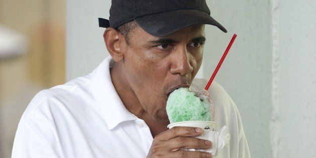 US President Barack Obama eats a shave ice at Island Snow in Kailua, Hawaii, January 3, 2011, on the last day of his two-week vacation. AFP PHOTO / Saul LOEB (Photo credit should read SAUL LOEB/AFP/Getty Images)