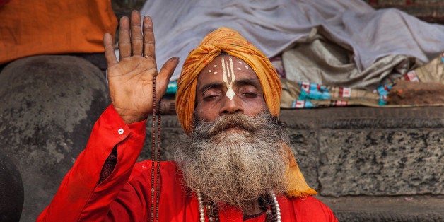 KATHMANDU, NEPAL - FEBRUARY 17: A Shadu, or holy man, prays inside Pashupatinath temple during the celebration of the Maha S